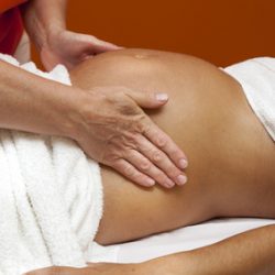 Young pregnant woman receiving relaxing massage